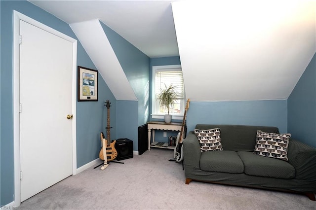 carpeted living room featuring lofted ceiling and baseboards