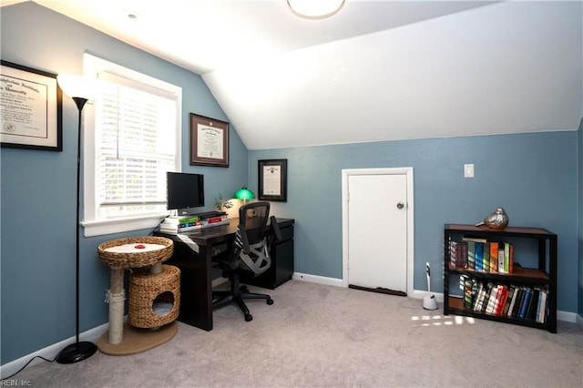 carpeted home office featuring lofted ceiling and baseboards