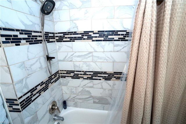 bathroom with shower / bath combination with curtain