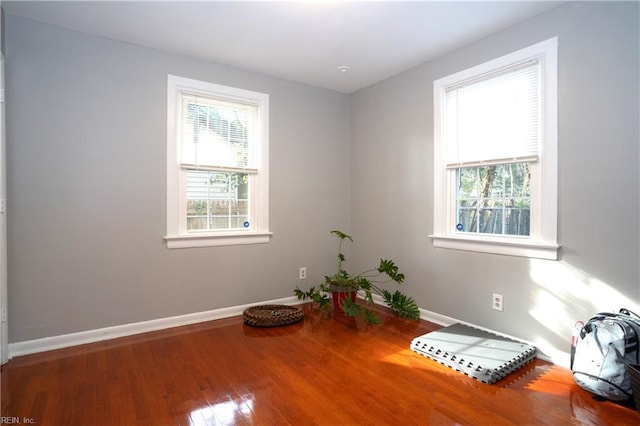 spare room featuring wood finished floors and baseboards