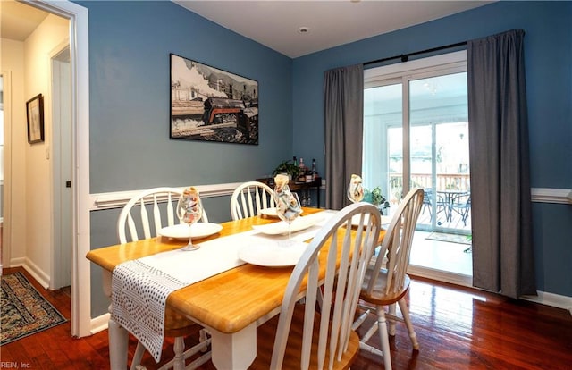 dining area with wood finished floors and baseboards