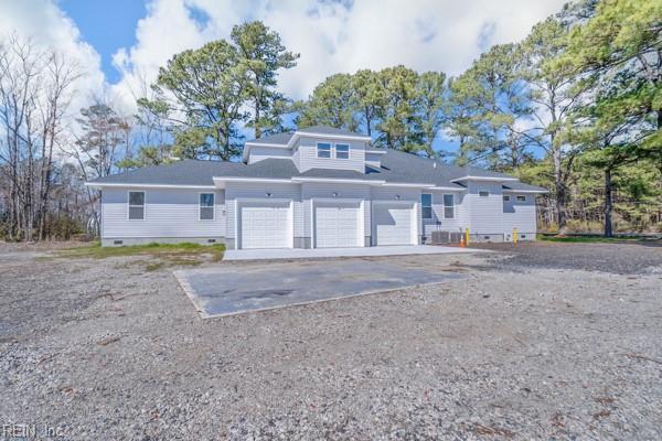 view of front facade featuring an attached garage, driveway, and crawl space