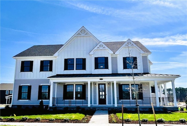 modern inspired farmhouse with covered porch, board and batten siding, and a standing seam roof