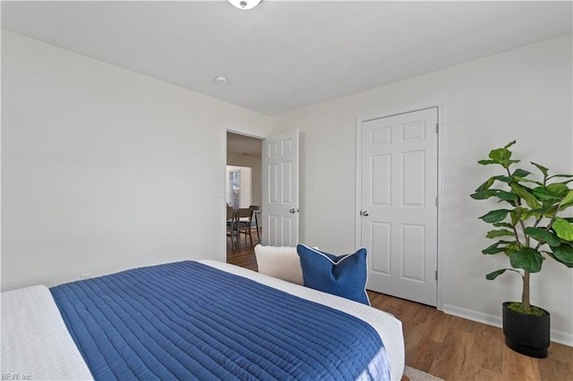 bedroom featuring baseboards and wood finished floors