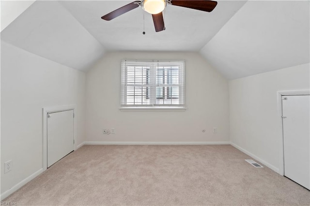 bonus room with carpet, visible vents, vaulted ceiling, and baseboards