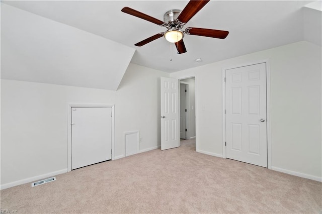 bonus room featuring baseboards, visible vents, vaulted ceiling, and carpet flooring