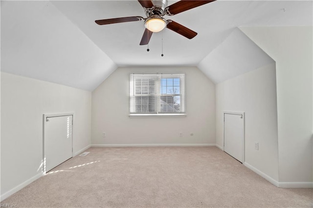 additional living space featuring vaulted ceiling, carpet, and baseboards