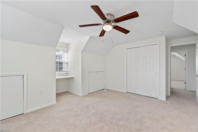 bonus room featuring a ceiling fan, carpet, lofted ceiling, and baseboards