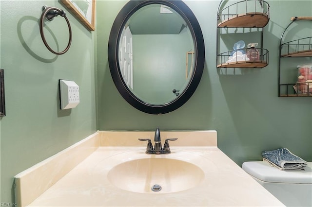 bathroom featuring toilet and vanity