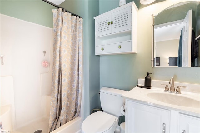 bathroom featuring curtained shower, toilet, and vanity