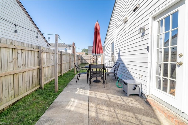 view of patio with outdoor dining area and a fenced backyard