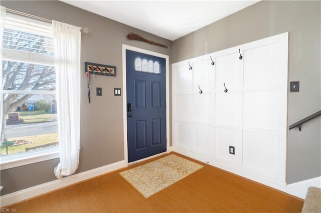 entryway with baseboards and light wood-style floors