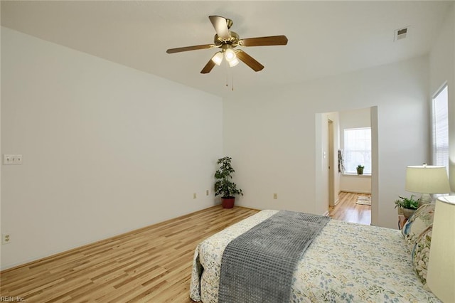 bedroom with ceiling fan, visible vents, and light wood-style floors