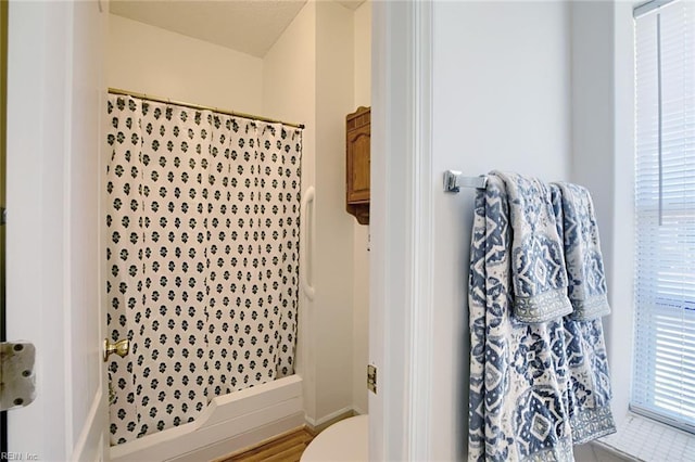 bathroom with a shower stall and a wealth of natural light