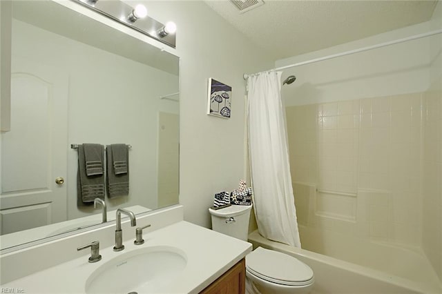 bathroom with shower / tub combo with curtain, visible vents, toilet, vanity, and a textured ceiling