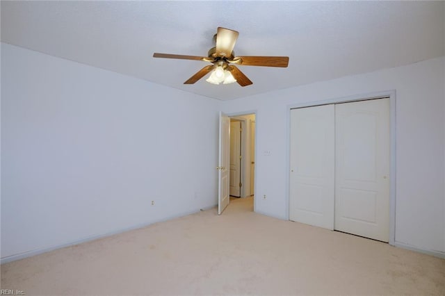 unfurnished bedroom featuring a closet, carpet, and a ceiling fan