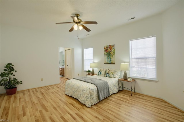 bedroom with multiple windows, wood finished floors, and visible vents