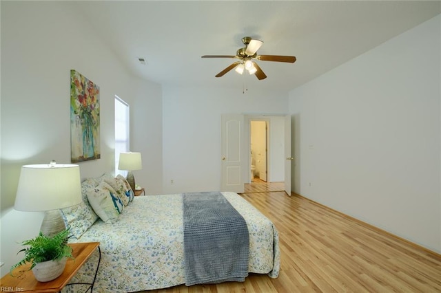 bedroom featuring ceiling fan, light wood finished floors, and visible vents