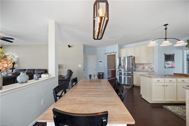 dining room with dark wood finished floors and ceiling fan