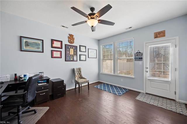 office space with dark wood-style floors, visible vents, and baseboards