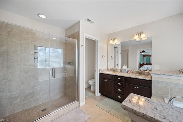 full bathroom featuring a stall shower, tile patterned flooring, visible vents, and toilet