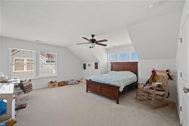 bedroom with lofted ceiling, ceiling fan, a textured ceiling, and light colored carpet