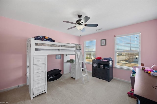 bedroom with visible vents, baseboards, a ceiling fan, and light colored carpet