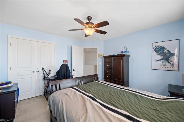 carpeted bedroom with ceiling fan and a closet