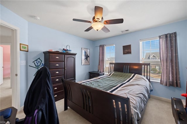 bedroom featuring light colored carpet, visible vents, ceiling fan, and baseboards