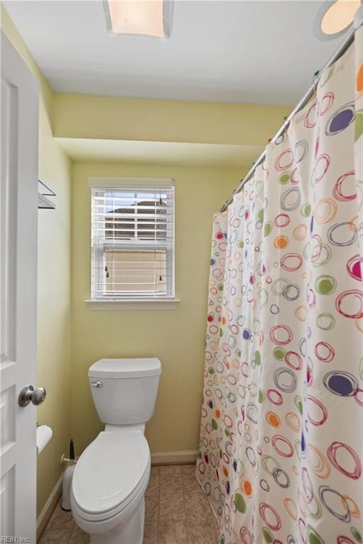 full bathroom with toilet, tile patterned flooring, and baseboards