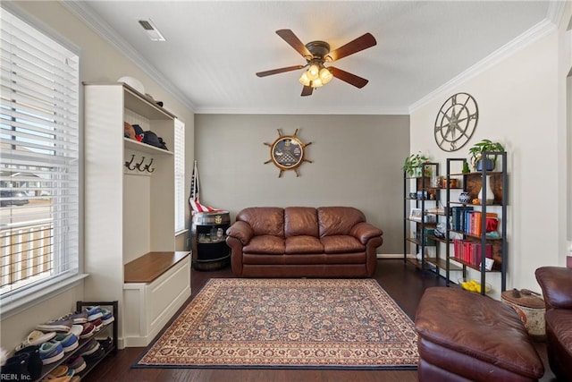 living room featuring crown molding, dark wood finished floors, and a ceiling fan