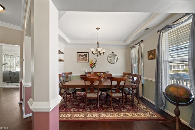 dining room featuring crown molding, dark wood finished floors, baseboards, and an inviting chandelier