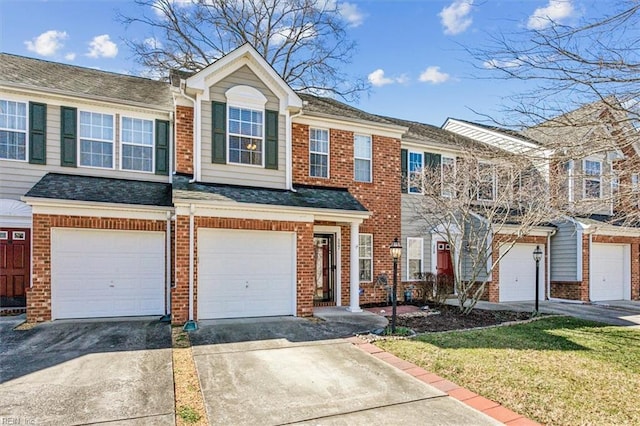 multi unit property featuring an attached garage, roof with shingles, concrete driveway, and brick siding