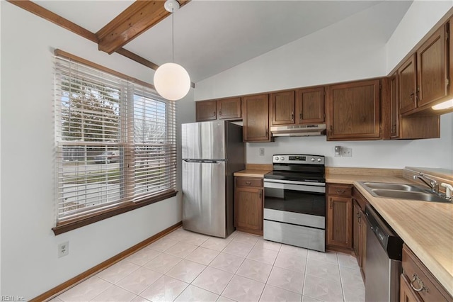 kitchen featuring vaulted ceiling with beams, under cabinet range hood, light countertops, appliances with stainless steel finishes, and a sink