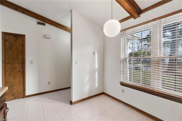 interior space featuring light tile patterned floors, visible vents, beam ceiling, and baseboards