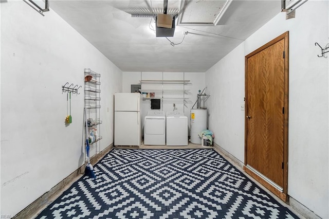 laundry room featuring water heater, laundry area, a garage, and washing machine and clothes dryer