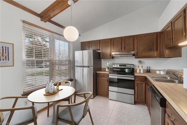 kitchen featuring under cabinet range hood, appliances with stainless steel finishes, light countertops, and a sink