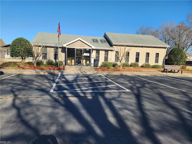 view of building exterior featuring uncovered parking