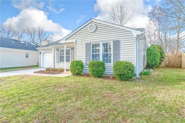 view of front of property with a front lawn, an attached garage, driveway, and fence