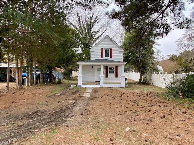 view of front of home with covered porch and fence