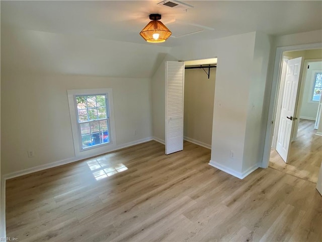 unfurnished bedroom with visible vents, a closet, light wood-style flooring, and baseboards