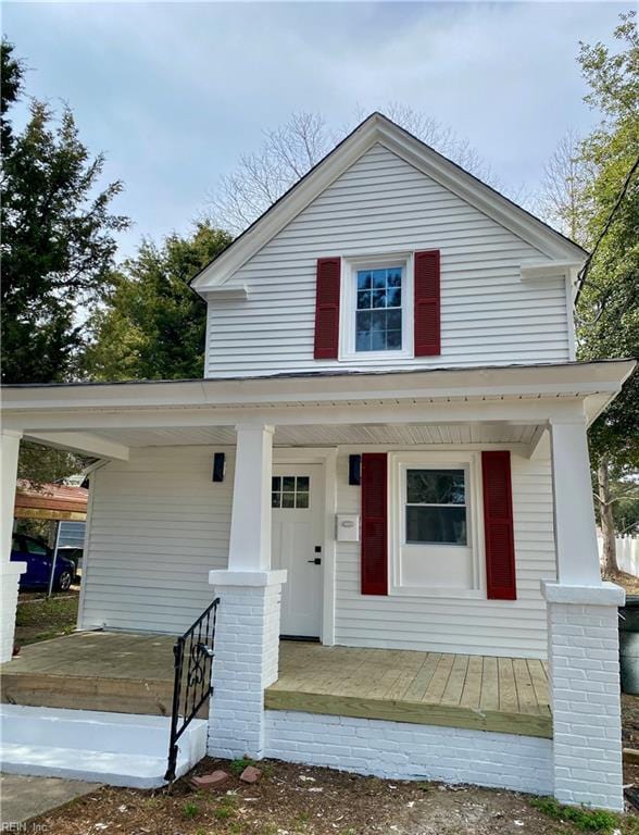 view of front of house with covered porch and an attached carport