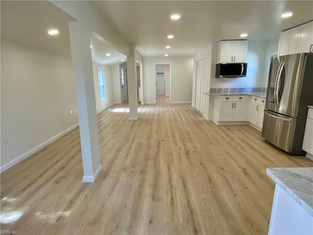 kitchen with light wood finished floors, baseboards, white cabinets, appliances with stainless steel finishes, and recessed lighting