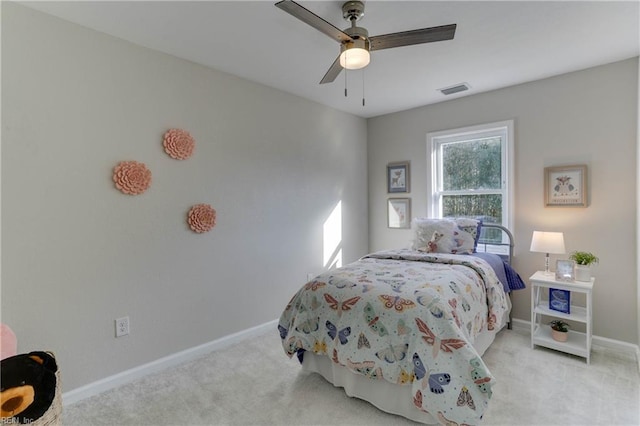 carpeted bedroom with visible vents, a ceiling fan, and baseboards