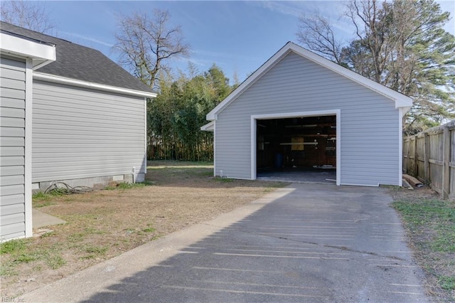 detached garage featuring fence