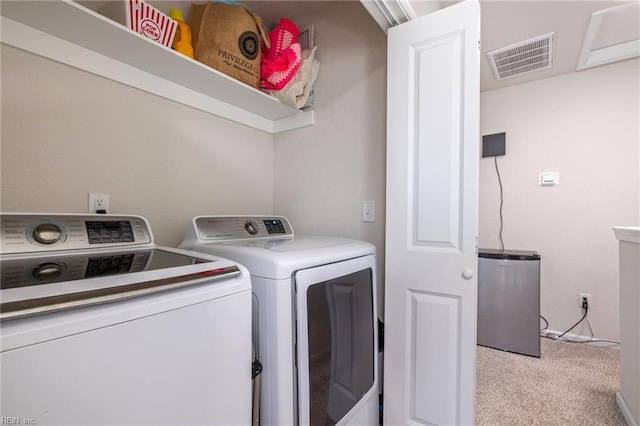 washroom with laundry area, separate washer and dryer, carpet flooring, and visible vents