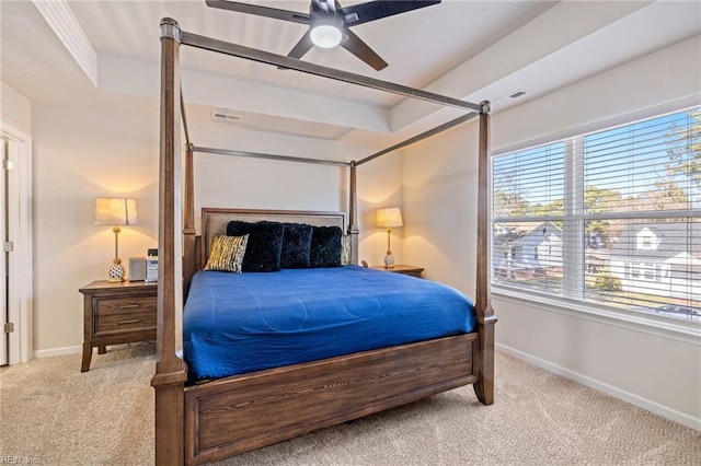 carpeted bedroom with a ceiling fan, a raised ceiling, visible vents, and baseboards