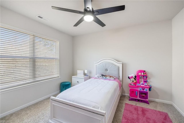 bedroom with a ceiling fan, visible vents, light carpet, and baseboards