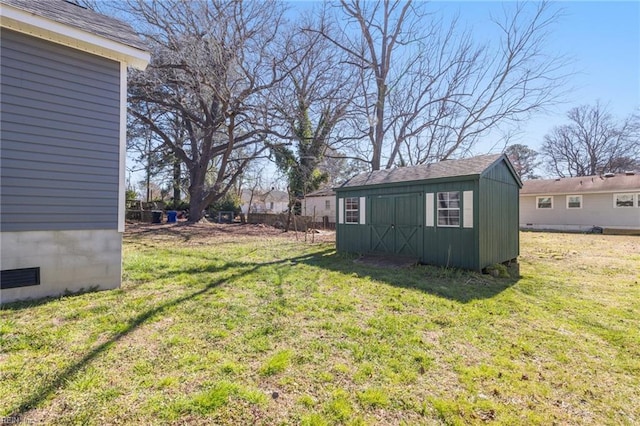 view of yard featuring a storage unit and an outbuilding