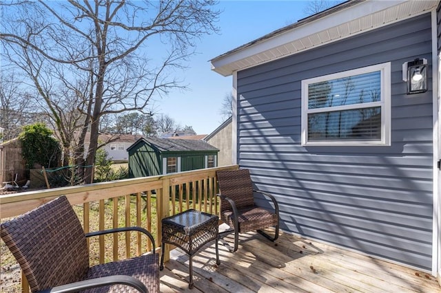 wooden terrace featuring an outbuilding